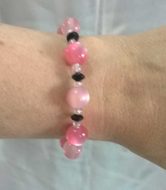 Pink, white and black beaded bracelet on an arm