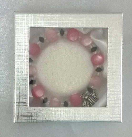 Pink, white and black beaded bracelet in closed box