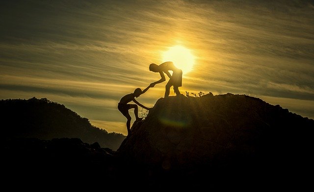 Helping another climb the hill